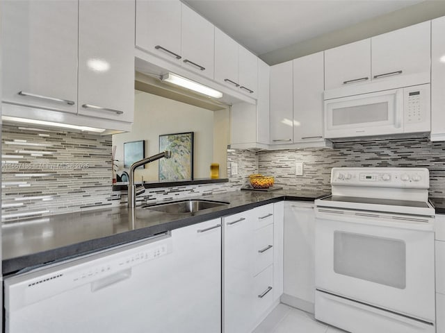 kitchen featuring decorative backsplash, sink, light tile patterned floors, white appliances, and white cabinets