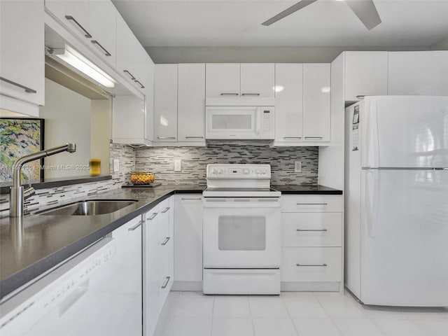 kitchen with ceiling fan, backsplash, sink, white appliances, and white cabinetry