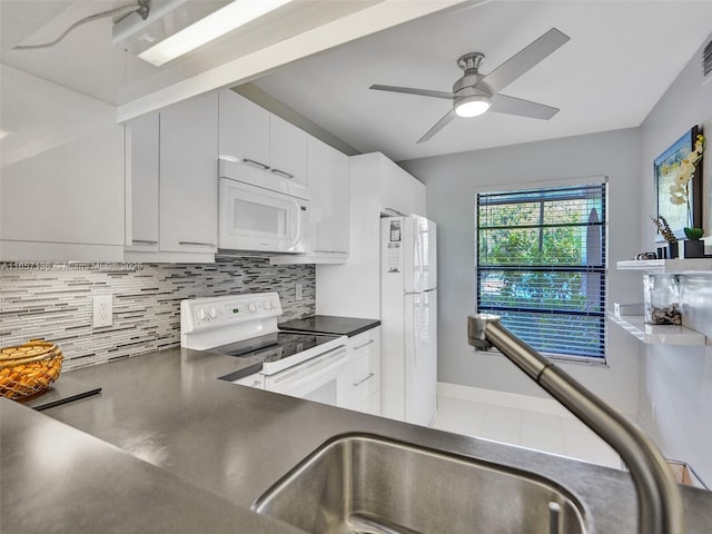 kitchen with white appliances, white cabinets, decorative backsplash, sink, and ceiling fan