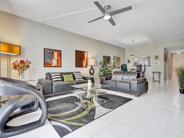 tiled living room featuring ceiling fan and a textured ceiling