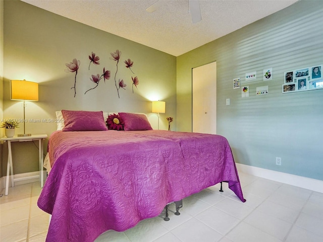 bedroom featuring a textured ceiling, ceiling fan, and tile patterned flooring