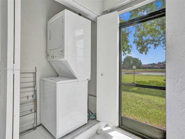 washroom featuring stacked washer and clothes dryer