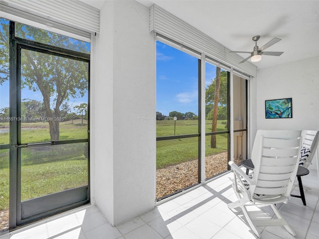 sunroom / solarium featuring ceiling fan