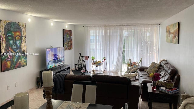 living room with a textured ceiling, plenty of natural light, and light tile patterned floors