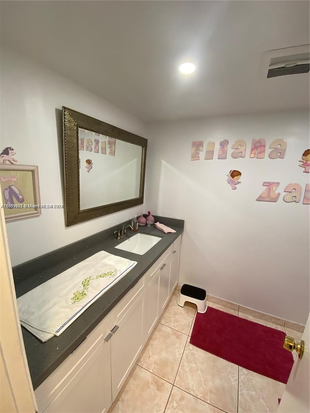 bathroom featuring tile patterned flooring and vanity