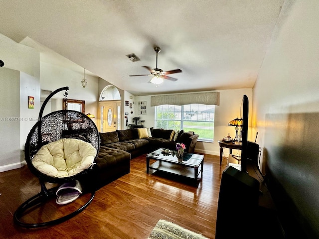 living room featuring lofted ceiling, wood-type flooring, a textured ceiling, and ceiling fan