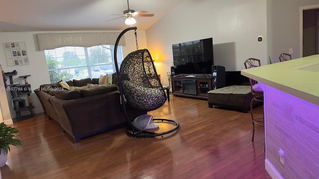 living room featuring ceiling fan, hardwood / wood-style floors, and vaulted ceiling