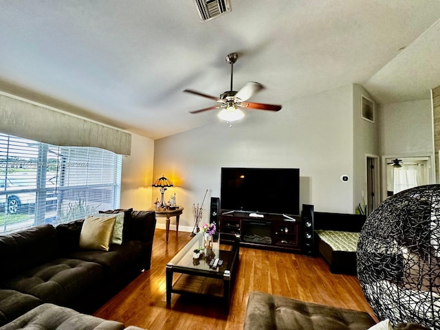 living room featuring lofted ceiling, wood-type flooring, and ceiling fan