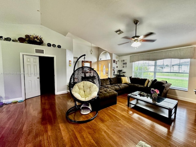 living room with ceiling fan, wood-type flooring, and vaulted ceiling