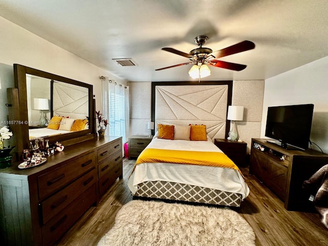 bedroom featuring ceiling fan and dark hardwood / wood-style flooring