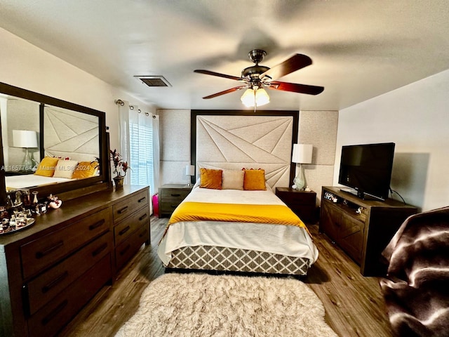 bedroom with ceiling fan and dark hardwood / wood-style flooring