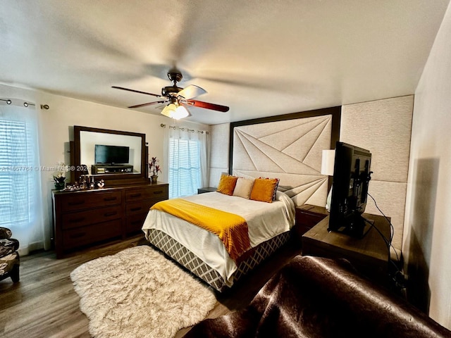 bedroom featuring ceiling fan and wood-type flooring