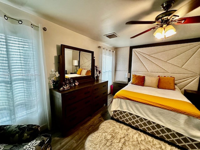 bedroom with dark wood-type flooring and ceiling fan