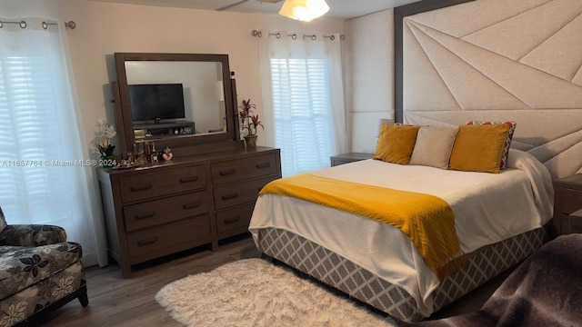 bedroom with dark hardwood / wood-style flooring