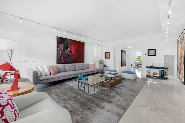 living room with track lighting and concrete flooring