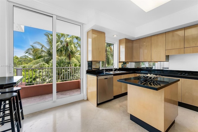 kitchen featuring a breakfast bar, dishwasher, a wealth of natural light, and a kitchen island