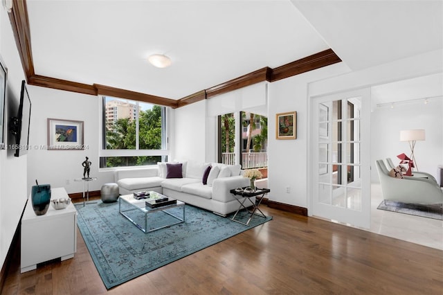 living room featuring ornamental molding, hardwood / wood-style floors, and french doors