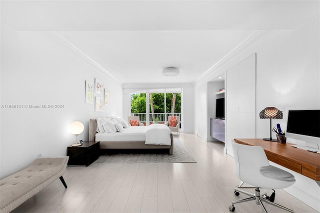 bedroom with ornamental molding and light wood-type flooring