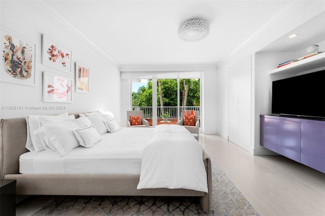 bedroom featuring crown molding, access to exterior, and wood-type flooring