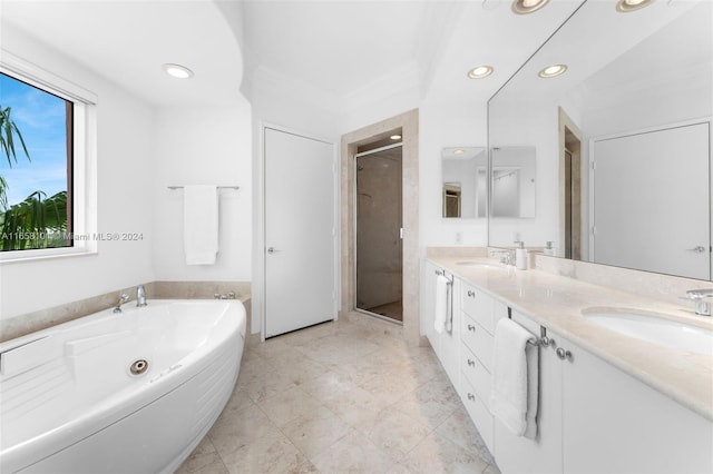 bathroom featuring vanity and independent shower and bath