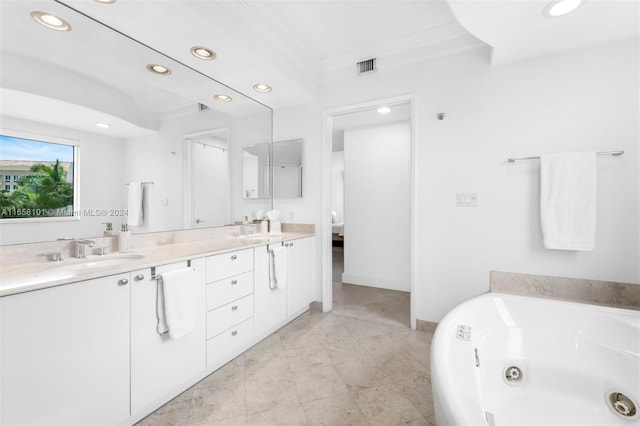 bathroom with vanity, a tub, and crown molding