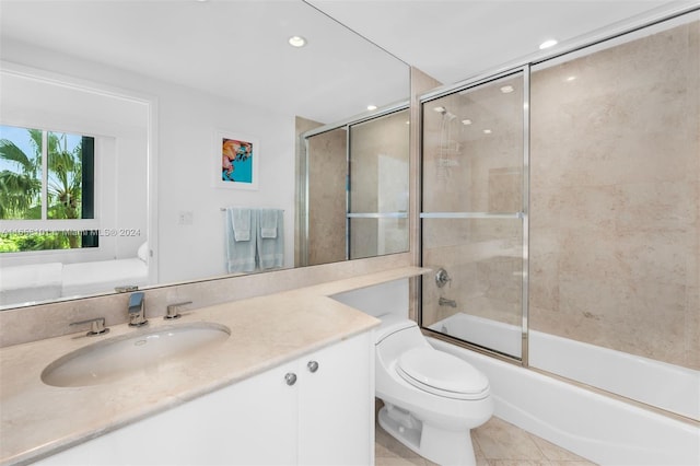 full bathroom featuring vanity, toilet, shower / bath combination with glass door, and tile patterned flooring