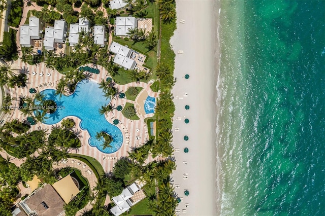 drone / aerial view featuring a water view and a view of the beach