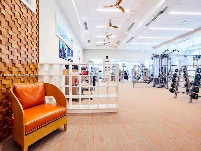 gym featuring french doors, carpet flooring, and ceiling fan