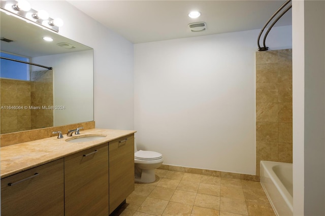 full bathroom featuring tiled shower / bath combo, tile patterned flooring, vanity, and toilet