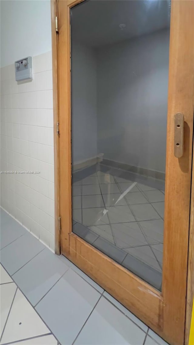 interior space with elevator and tile patterned floors