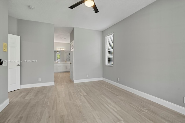 unfurnished room with ceiling fan, light hardwood / wood-style floors, and a wealth of natural light