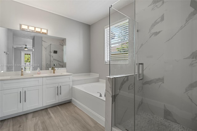 bathroom featuring vanity, separate shower and tub, ceiling fan, and a wealth of natural light