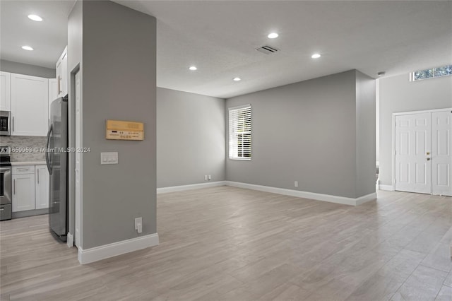 unfurnished living room featuring light wood-type flooring