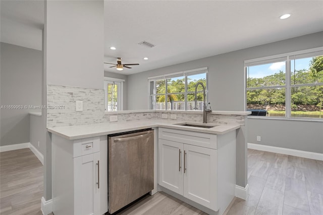 kitchen featuring ceiling fan, sink, white cabinetry, and stainless steel dishwasher