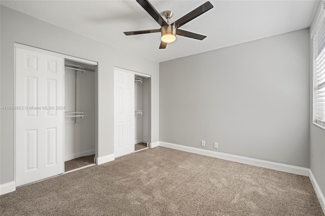 unfurnished bedroom with carpet, ceiling fan, and a textured ceiling