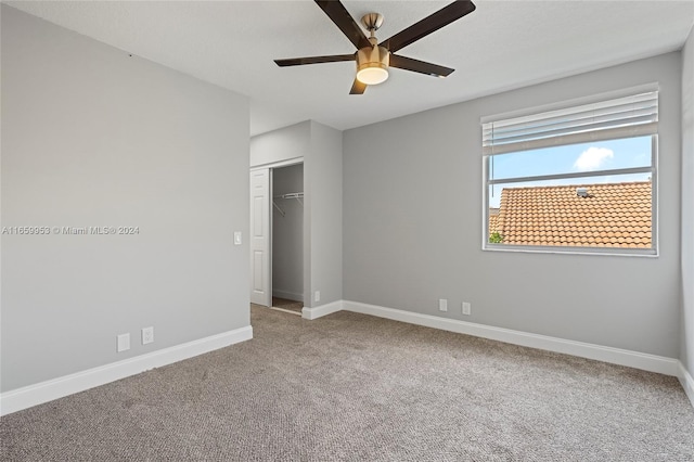 unfurnished bedroom with ceiling fan, a closet, and carpet