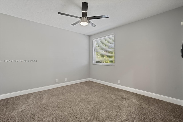 carpeted spare room with ceiling fan and a textured ceiling