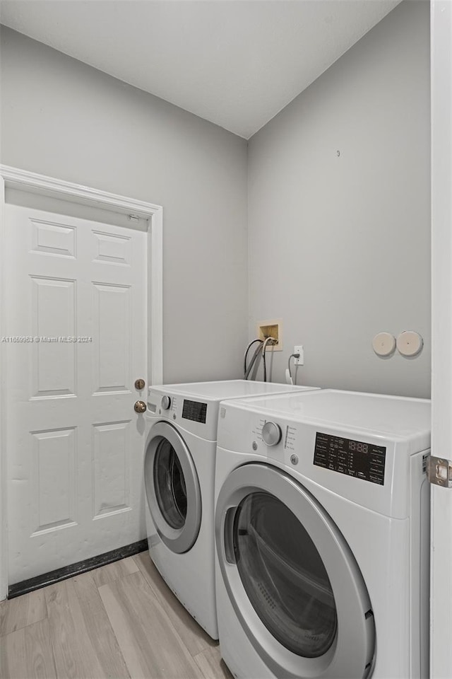 laundry room featuring light wood-type flooring and independent washer and dryer