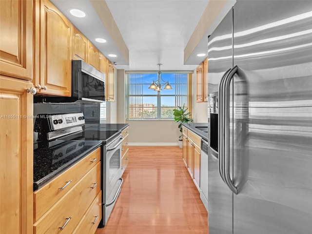 kitchen featuring pendant lighting, an inviting chandelier, light brown cabinetry, stainless steel appliances, and light wood-type flooring