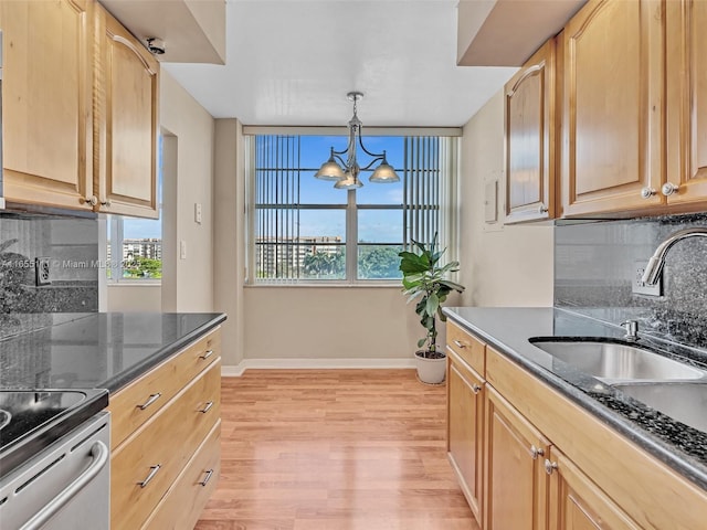 kitchen with sink, an inviting chandelier, backsplash, decorative light fixtures, and light brown cabinets