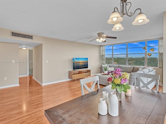 900 Saint Charles Pl Unit 718, Pembroke Pines, FL 33026 - dining space featuring a ceiling fan, light wood-style floors, and a textured ceiling