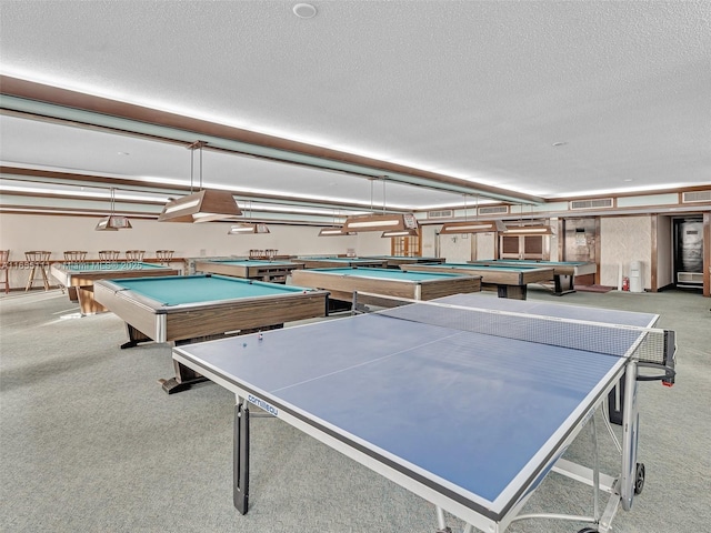 recreation room with light colored carpet, billiards, and a textured ceiling