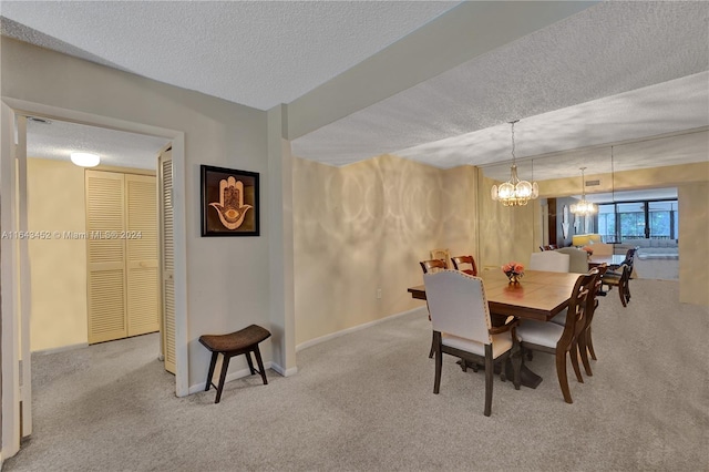 carpeted dining room with a textured ceiling and an inviting chandelier