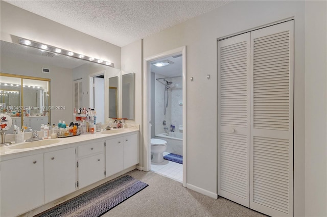 full bathroom featuring tiled shower / bath, vanity, a textured ceiling, and toilet