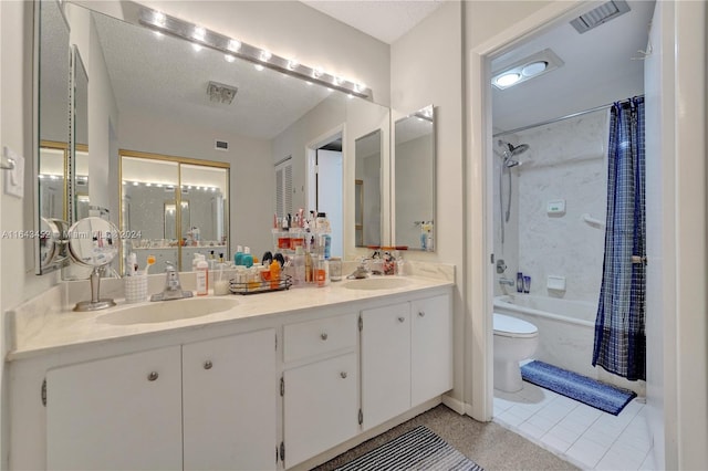 full bathroom with shower / bath combination with curtain, a textured ceiling, toilet, vanity, and tile patterned floors