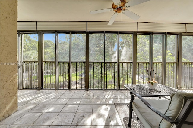 unfurnished sunroom featuring ceiling fan