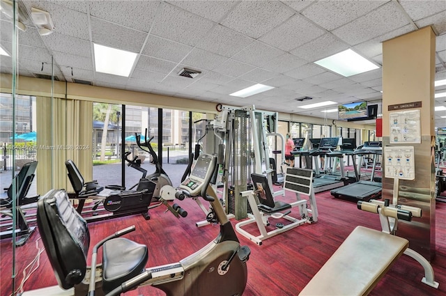 gym with a paneled ceiling