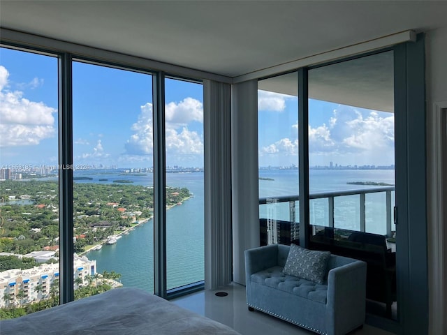 unfurnished bedroom featuring a wall of windows, multiple windows, and a water view