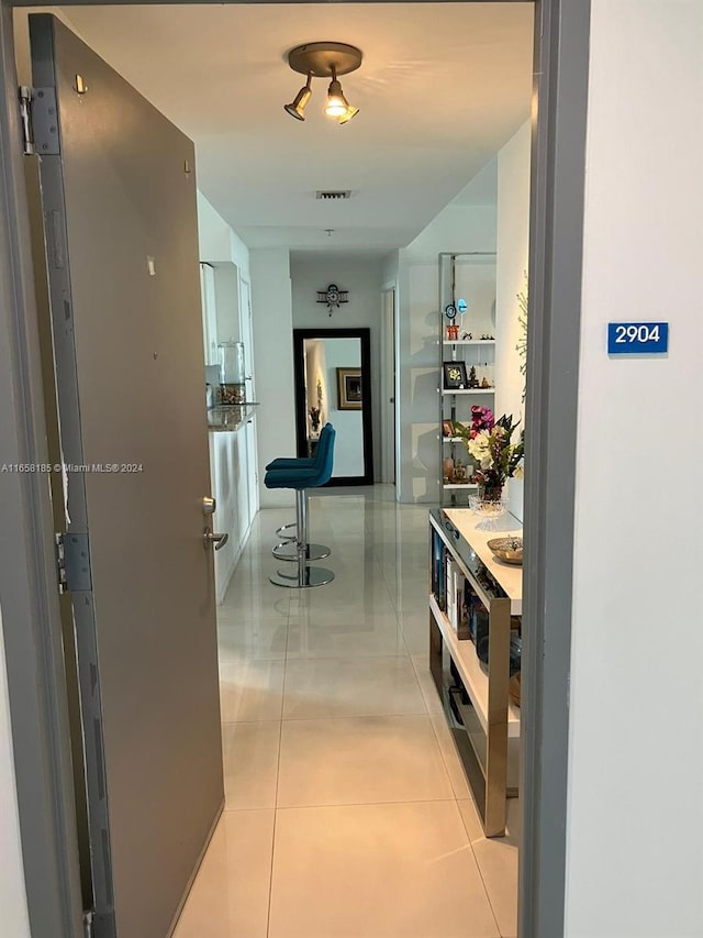 hallway featuring light tile patterned flooring