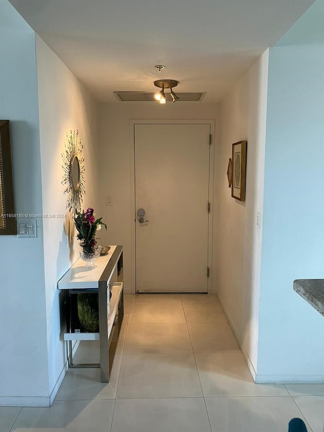 corridor featuring light tile patterned flooring